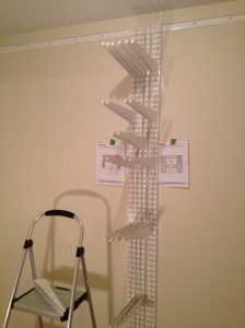Plans taped to the corresponding walls and hanging standards grouped to hang the brackets.